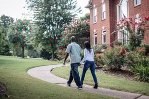 couple walking outside of house