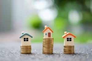 houses on stacks of money