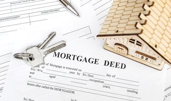 Mortgage deed paperwork and house keys