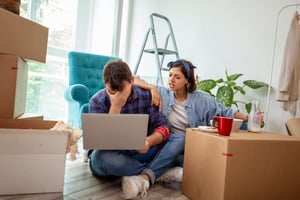 A stressed out couple searching for a home online.