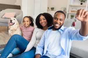 family in new home holding house keys