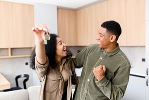 Couple celebrating getting the keys to their new home